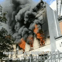 A Building Is On Fire With Smoke Coming Out Of It GIF
