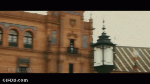 Building With Rino Obscura Sign And Lamp Post GIF