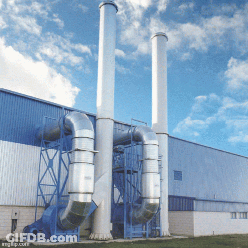 A Building With A Lot Of Pipes And Chimneys On The Side Of It GIF