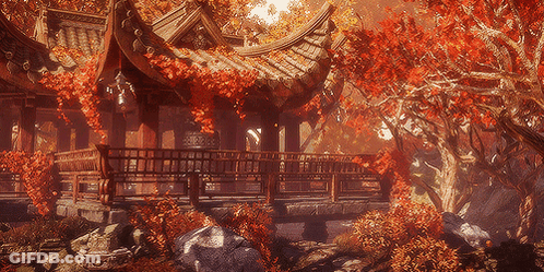 A Building With A Roof That Has Red Leaves Hanging From It GIF