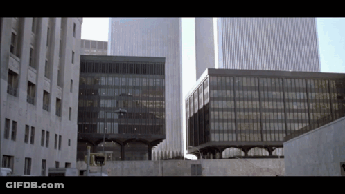A Building With A Sign That Says No Parking GIF