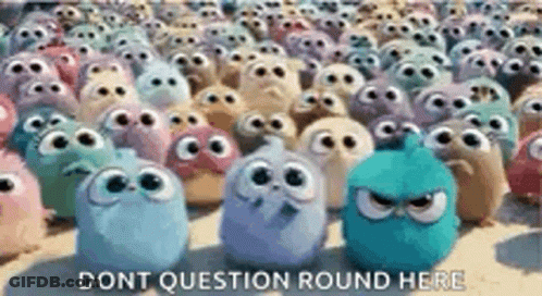 A Bunch Of Angry Birds Are Standing Next To Each Other On A Beach . GIF