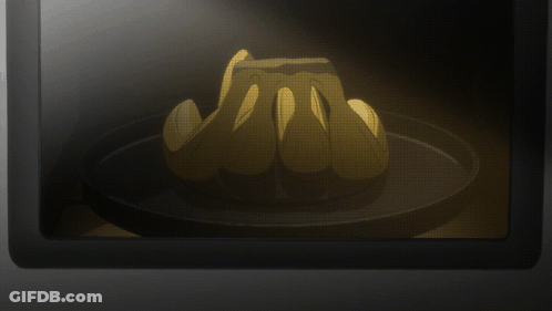 A Bunch Of Bananas Sitting On A Black Plate GIF