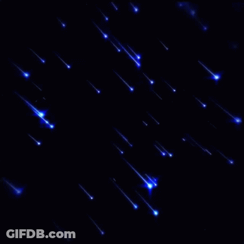 A Bunch Of Blue Lights Are Falling In The Dark GIF