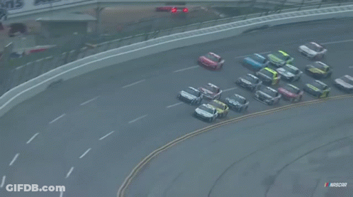 A Bunch Of Cars Are Racing On A Race Track With Nascar Written On The Bottom GIF