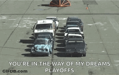 A Bunch Of Cars Are Sitting On Top Of Each Other In A Parking Lot And A Truck Is Carrying Them . GIF