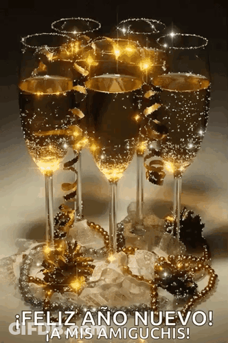 A Bunch Of Champagne Glasses With The Words Feliz Ano Nuevo A Mis Amiguchis GIF