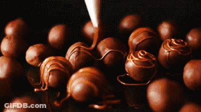 A Bunch Of Chocolate Balls Are Sitting On A Table With Graydriver Written On The Bottom GIF