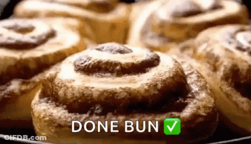 A Bunch Of Cinnamon Rolls In A Skillet With The Words `` Done Bun '' Written On It . GIF