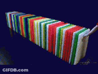 A Bunch Of Colorful Papers Are Stacked On Top Of Each Other On A Black Background GIF