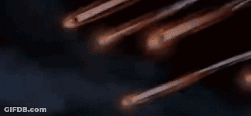 A Bunch Of Comets Are Flying Through The Night Sky GIF
