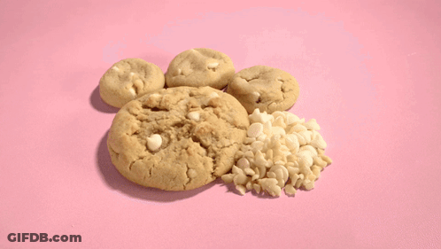 A Bunch Of Cookies On A Pink Surface GIF