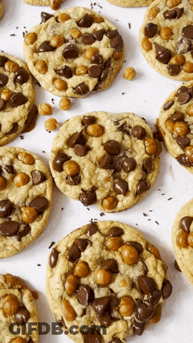 A Bunch Of Cookies With Chocolate Chips And Caramel Bits On Them GIF
