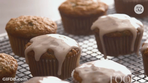 A Bunch Of Cupcakes On A Cooling Rack With The Number 52 On The Bottom Right GIF