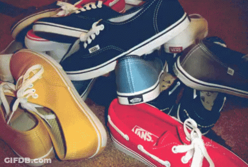 A Bunch Of Different Colored Vans Shoes Stacked On Top Of Each Other GIF