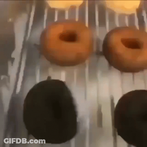 A Bunch Of Donuts Are Being Cooked On A Grill GIF