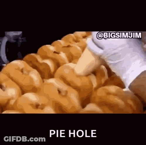 A Bunch Of Donuts Are Sitting On Top Of Each Other With The Words Pie Hole Written In The Corner . GIF