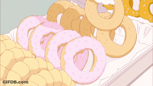 A Bunch Of Donuts Are Stacked On Top Of Each Other On A White Surface GIF