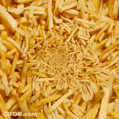 A Bunch Of French Fries Are Scattered In A Circular Pattern GIF