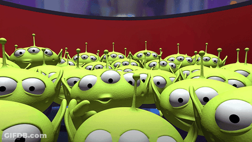 A Bunch Of Green Aliens From Toy Story Are Looking At Something GIF