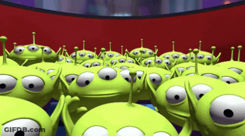A Bunch Of Green Aliens From Toy Story Are Standing In A Room GIF