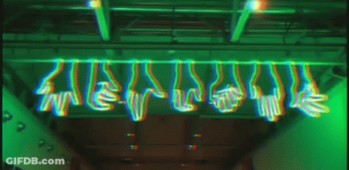 A Bunch Of Hands Are Hanging From The Ceiling In A Green Light GIF