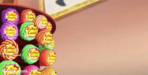 A Bunch Of Lollipops Are Lined Up On A Shelf GIF