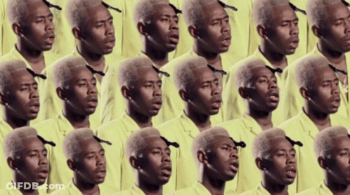 A Bunch Of Men In Yellow Shirts Are Singing Together GIF