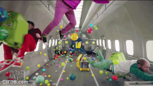 A Bunch Of People Are Flying Through The Air With Balloons And Luggage GIF
