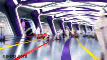 A Bunch Of People Are Walking Down A Hallway With Purple And White Walls GIF