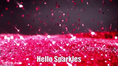 A Bunch Of Pink Glitter Is Falling On A Red Surface . GIF