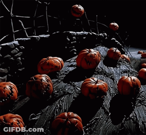 A Bunch Of Pumpkins And Ghosts Are On A Tree Trunk GIF