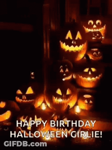 A Bunch Of Pumpkins Are Sitting Next To Each Other In A Dark Room . GIF