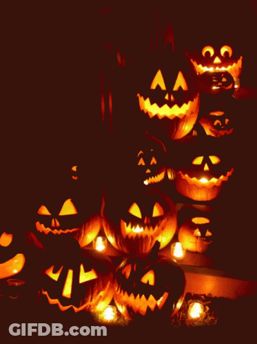 A Bunch Of Pumpkins With Faces Carved In Them GIF