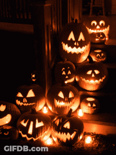 A Bunch Of Pumpkins With Faces Carved On Them GIF