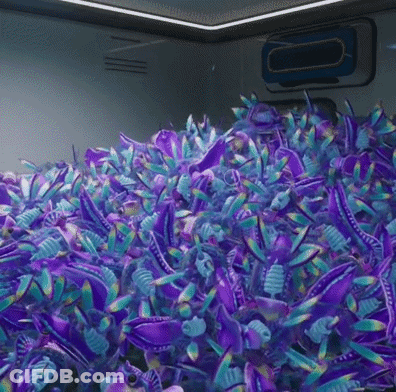A Bunch Of Purple And Blue Stuffed Animals Are Sitting On Top Of Each Other . GIF
