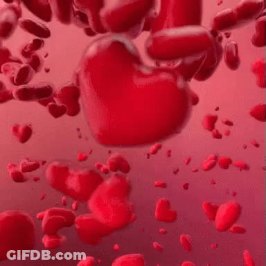 A Bunch Of Red Hearts Are Floating In The Air On A Pink Background . GIF
