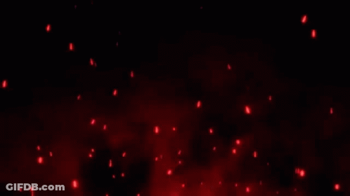 A Bunch Of Red Sparks Are Flying In The Air On A Black Background . GIF