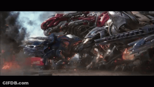 A Bunch Of Robots Are Fighting Each Other With Smoke Coming Out Of Them GIF