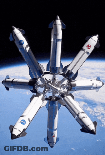 A Bunch Of Rockets Are Lined Up In A Circle And One Of Them Has Nasa On It GIF