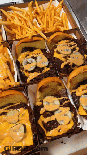 A Bunch Of Sandwiches And French Fries In A Box GIF