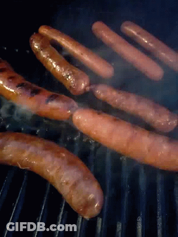 A Bunch Of Sausages Cooking On A Grill With Smoke Coming Out Of Them GIF