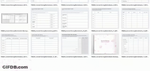 A Bunch Of Sheets Of Paper With Numbers On Them Are Lined Up On A Table . GIF