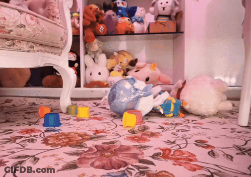 A Bunch Of Stuffed Animals Are On The Floor Including A Stuffed Unicorn GIF