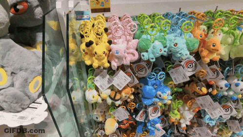 A Bunch Of Stuffed Pokemon Are Displayed On A Shelf In A Store GIF