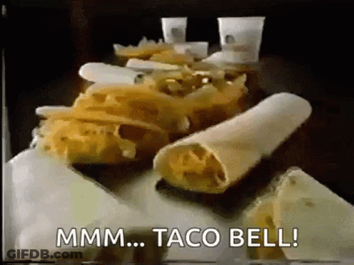 A Bunch Of Tacos Are Sitting On A Table With The Words Taco Bell Written On The Bottom . GIF