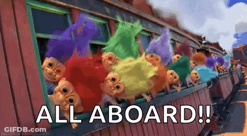 A Bunch Of Trolls Are Sitting On A Train With The Words `` All Aboard '' Written On It . GIF