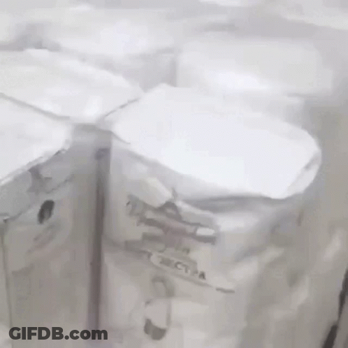 A Bunch Of White Boxes Are Sitting On A Table . GIF