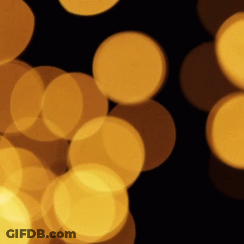A Bunch Of Yellow Circles Are Floating In The Air GIF
