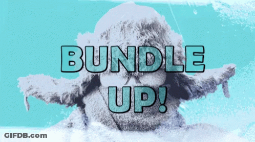 A Bundle Up Sign With A Statue Of A Person In The Background GIF